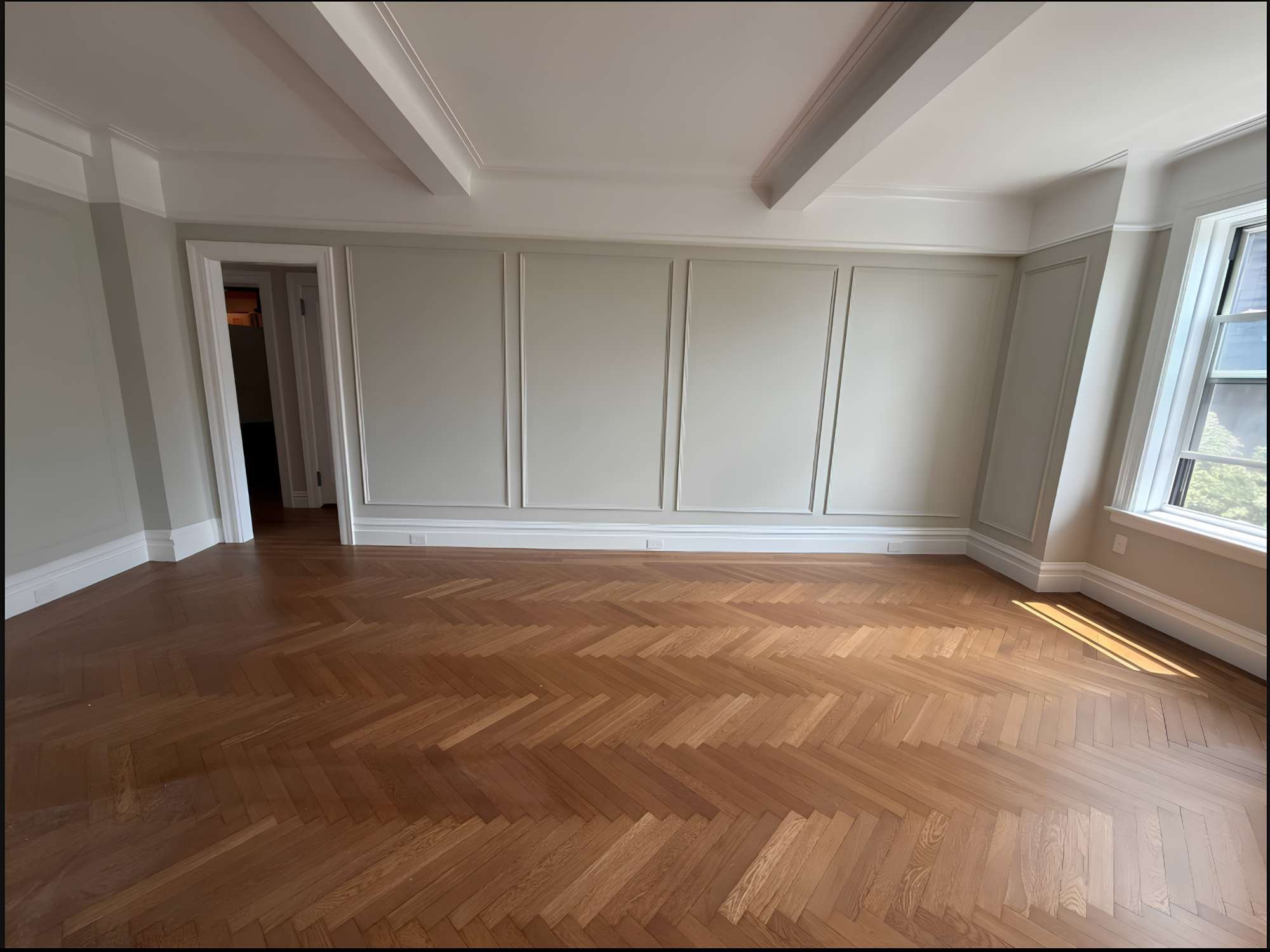 Image of renovated room with wall molding and coffered ceiling by Modo Renovations in Manhattan, NY