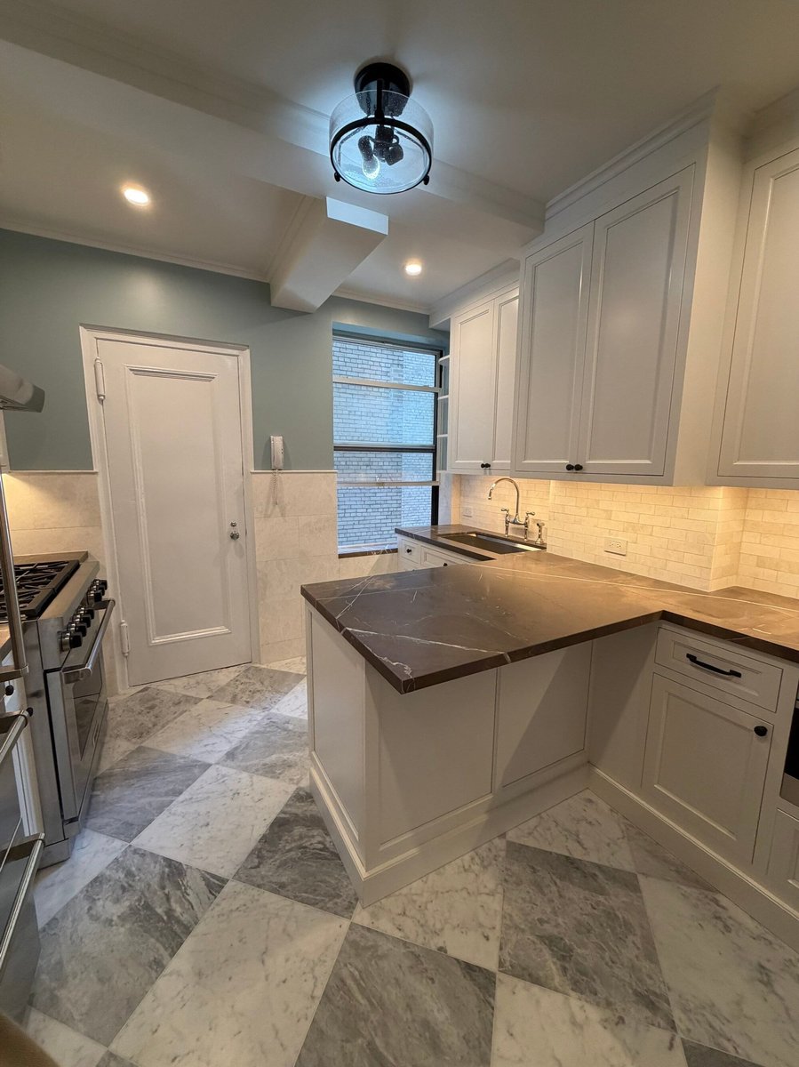 modo renovations kitchen remodeling in manhattan ny with dark marble peninsula counter and pantry door