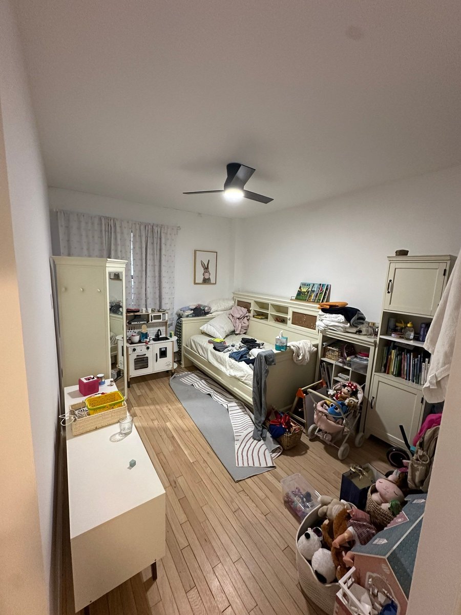 apartment renovation childs bedroom with hardwood floors ceiling fan cream furniture and rabbit wall art in manhattan valley ny by modo renovations