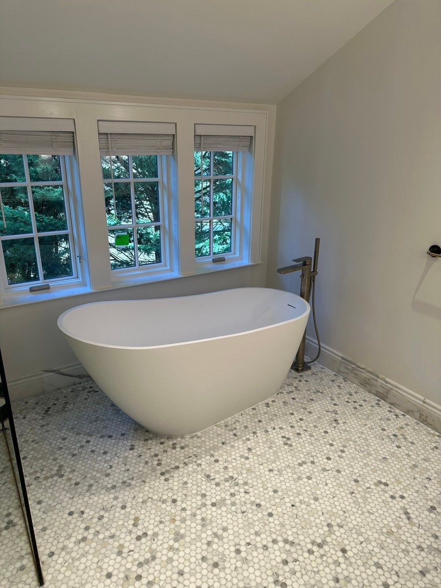 freestanding bathtub below windows in finished bathroom by modo renovations in rye ny home remodel