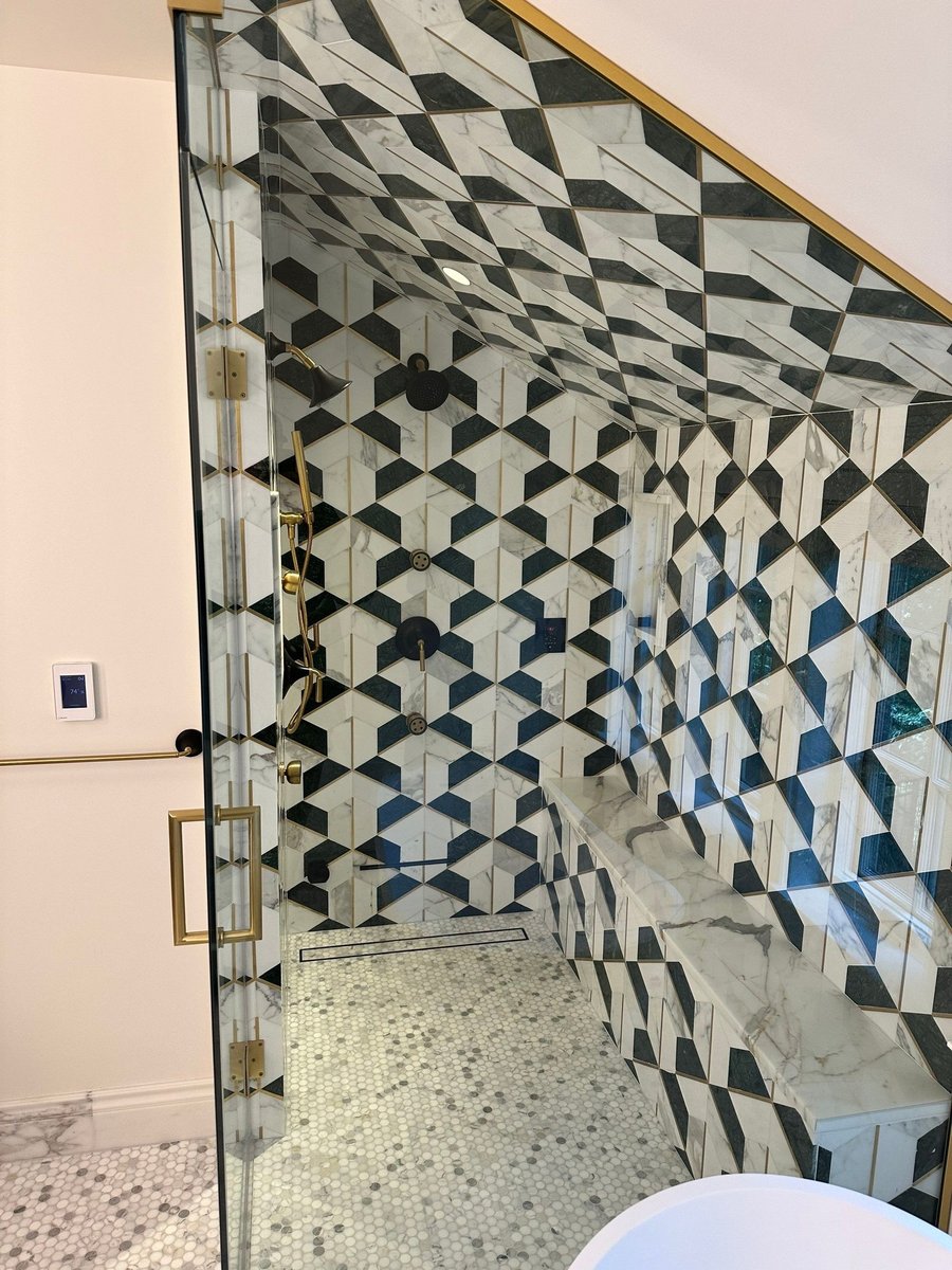 glass shower enclosure and patterned tile accent wall by modo renovations in rye ny home remodel view 1