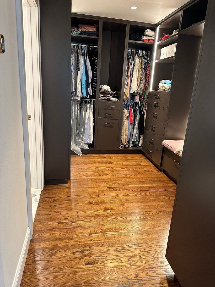 walk in closet entrance with hardwood floor and dark cabinetry by modo renovations in rye ny home remodel