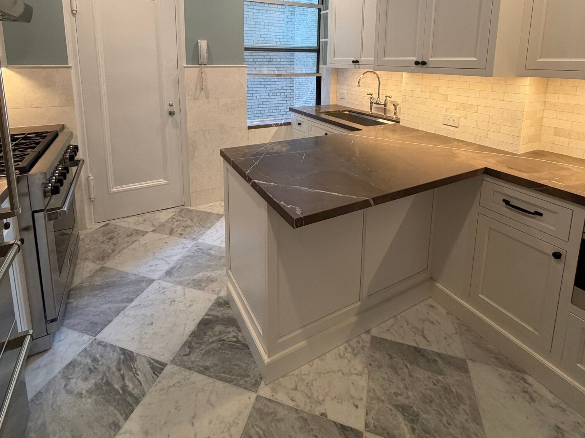 modo renovations kitchen remodeling in manhattan ny with dark marble peninsula counter and pantry door